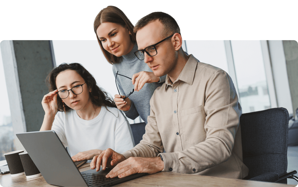 group-of-coworkers-looking-at-laptop-cf