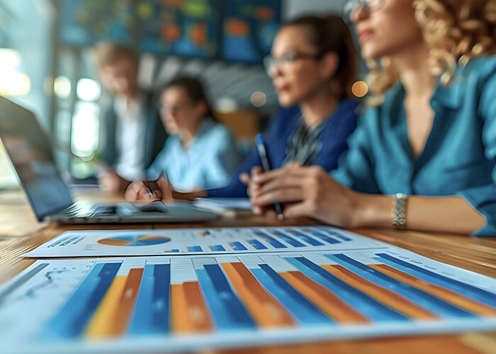 group-people-sit-table-with-graph-that-says-blue-it-sm