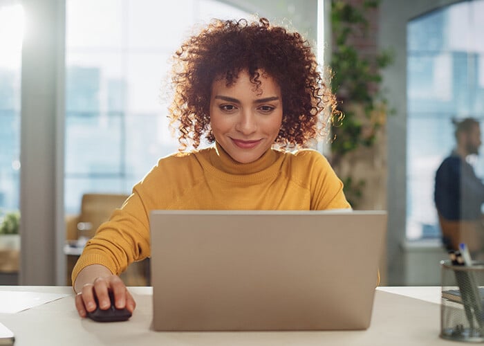 person-enjoying-a-positive-expeience-using-a-laptop-at-work
