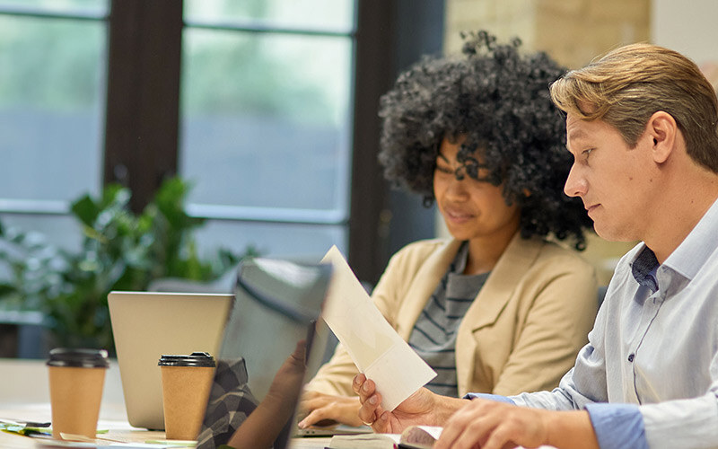 business-people-working-together-two-male-female-coworkers-looking-laptop-screen-analyzing-project-results-while-sitting-together-table-modern-office-coworking-space-thumb