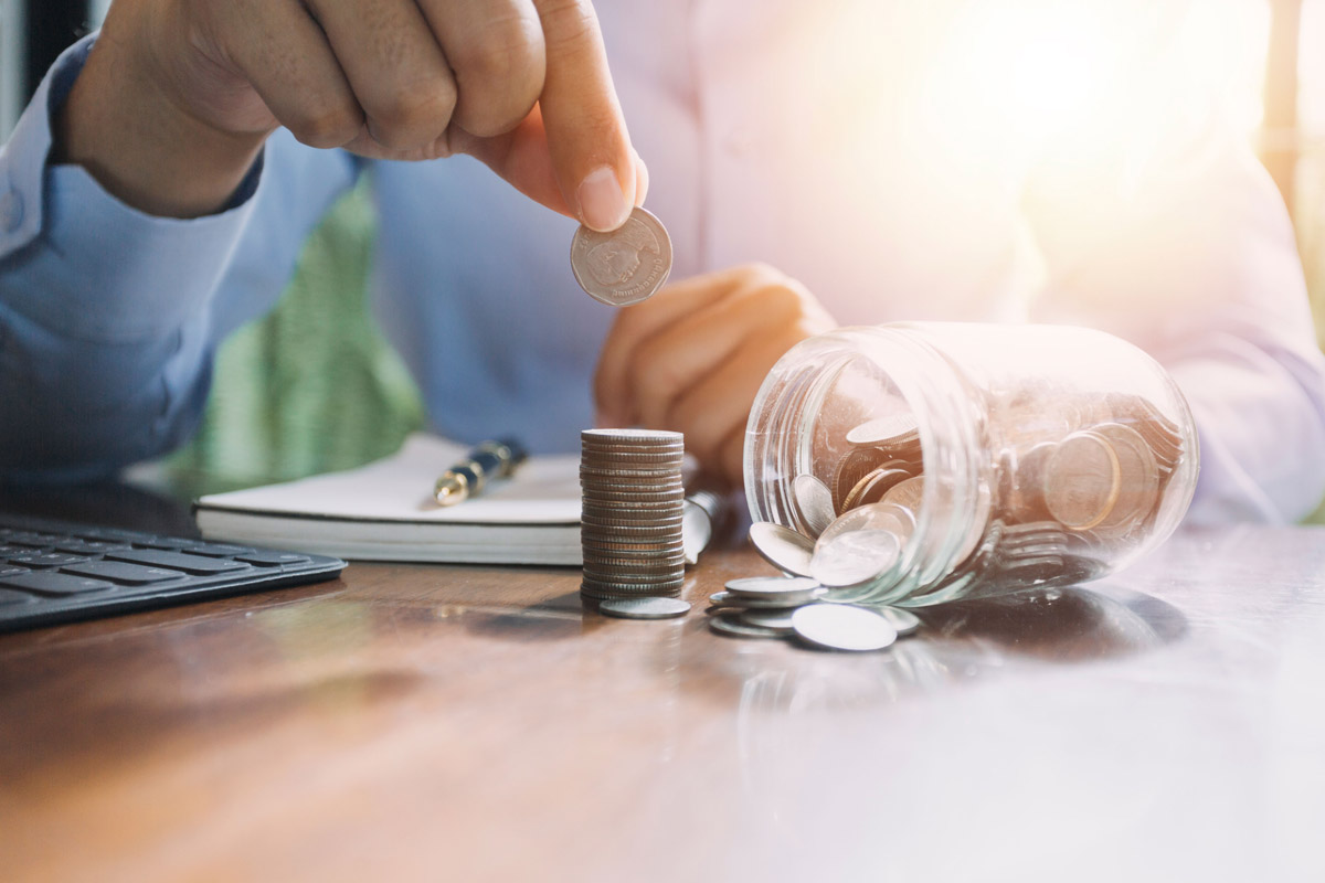businessman-holding-coins-putting-glass-concept-saving-money-finance-accounting