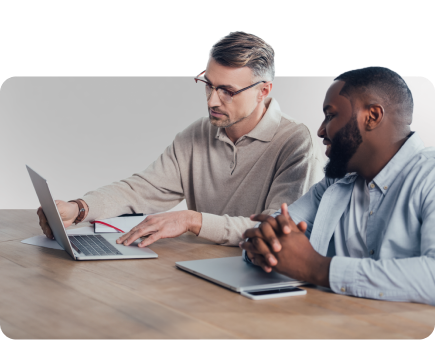 businessman-using-laptop-talking-with-smiling-colleague