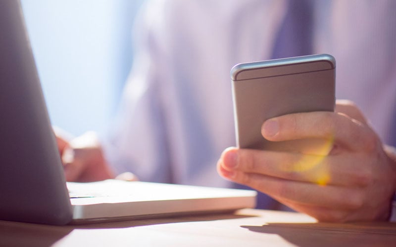 business man holding phone