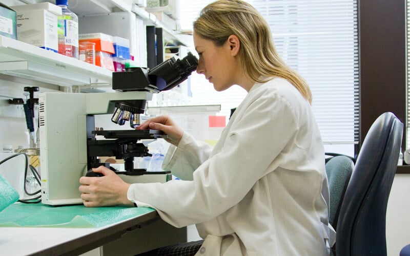 healthcare-worker-looking-in-microscope