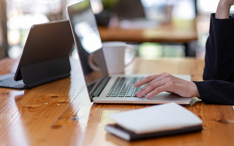 midsection-woman-using-laptop-table-thumb