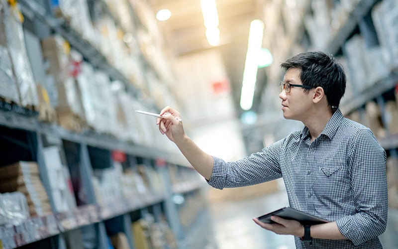 worker-taking-inventory-in-a-warehouse-thumb